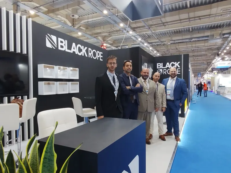 A second view of the Black Rope exhibition stand and a group beside the aisle.