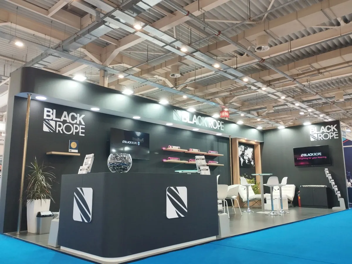 Black Rope exhibition stand with meeting tables and product displays.